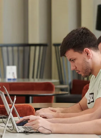 Carlos Morales working at a laptop